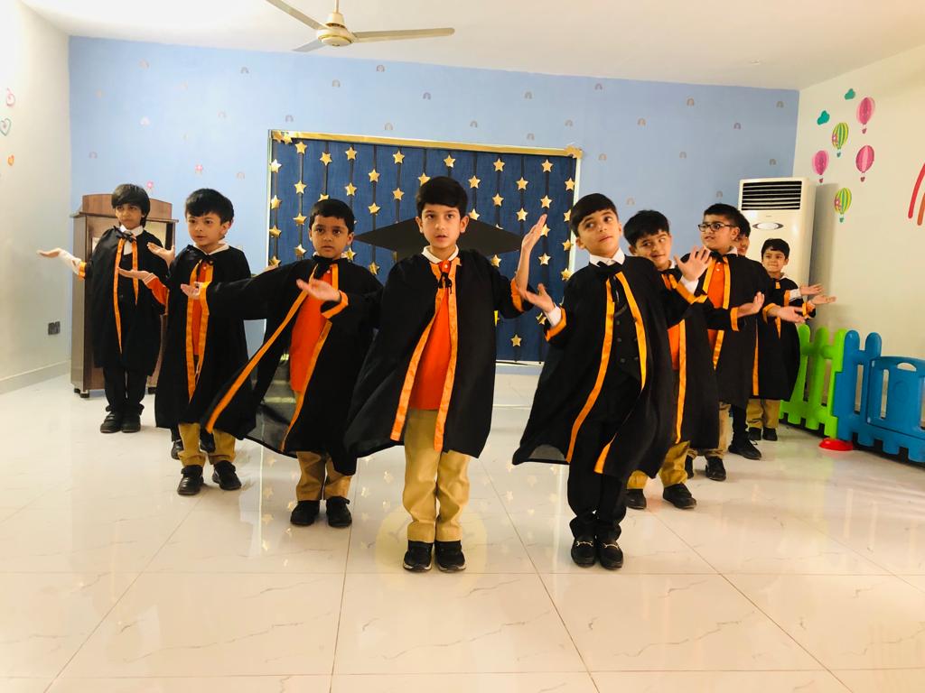 Young boys are on stage on Kindergarten Graduation