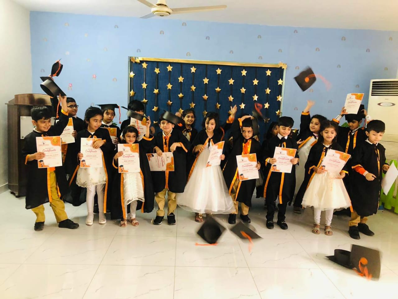 The children are celebrating their achievements of Kindergarten Graduation