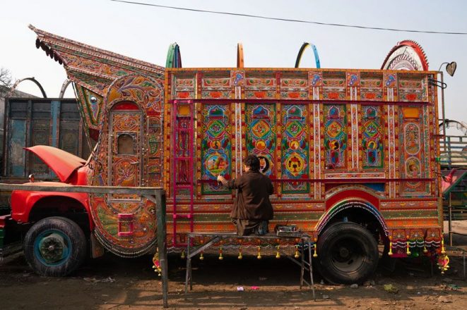 A Painter works on his Truck at his workshop in Rawalpindi, Pakistan